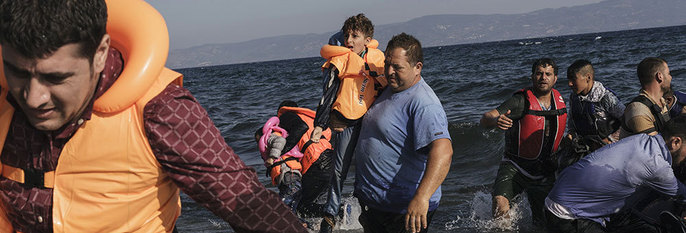 HJELPER: Nordmenn hjelper flyktninger som kommer til Hellas. De deler ut klær og sko.